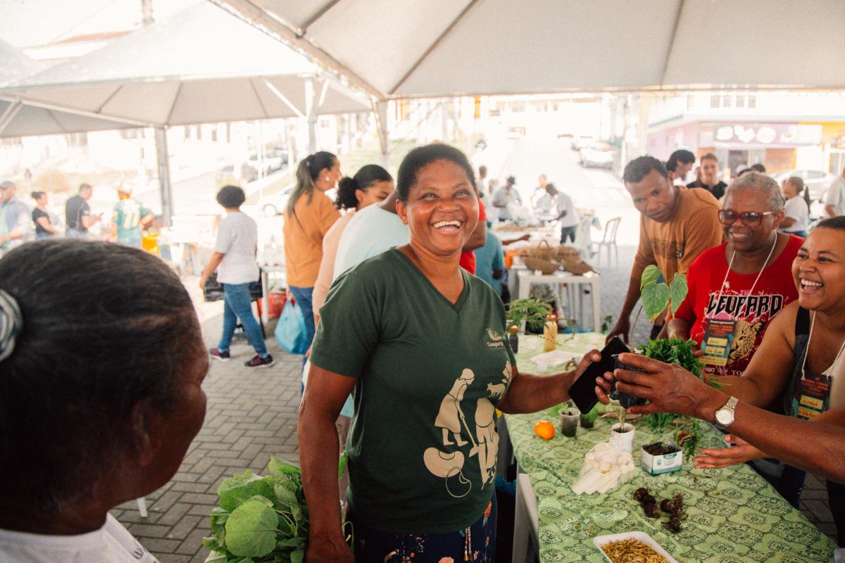 Dona Rosana de Almeida (ao centro), do Quilombo Nhunguara, trocando sementes com o Quilombo São Pedro na Feira de Troca de Sementes e Mudas